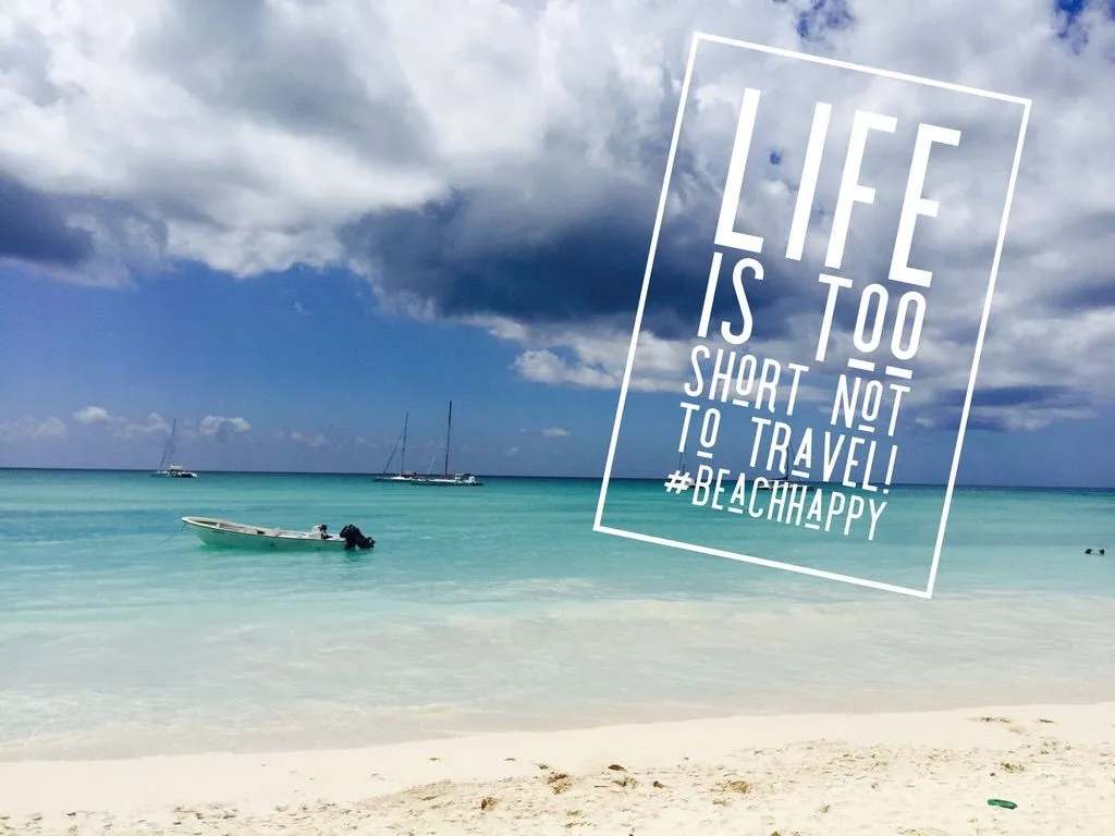 Sailboats anchored in calm turquoise Caribbean water with white sand beach — Life Is Too Short Not To Travel